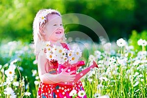 Little girl in daisy flower field