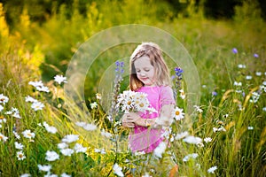 Little girl in daisy flower field