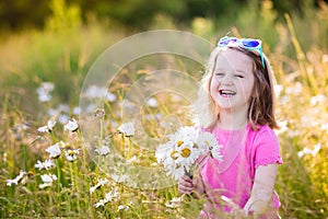 Little girl in daisy flower field