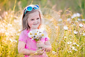 Little girl in daisy flower field