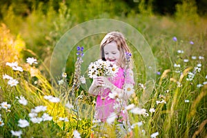 Little girl in daisy flower field