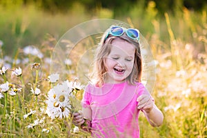 Little girl in daisy flower field