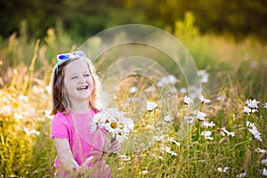 Little girl in daisy flower field