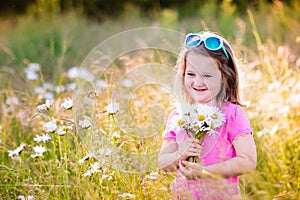 Little girl in daisy flower field