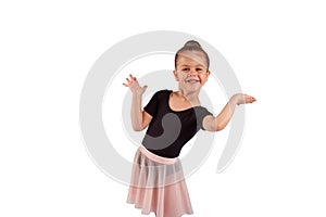 A little girl in a dance suit gracefully shows somewhere with her hand