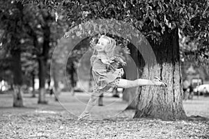 Little girl dancer jump in summer park