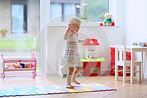 Little girl dancing indoors