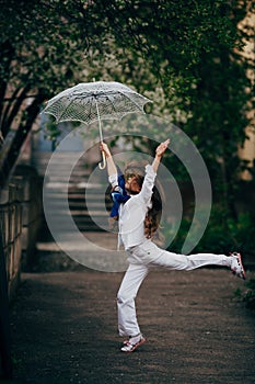 Little girl dancing with lace ambrella