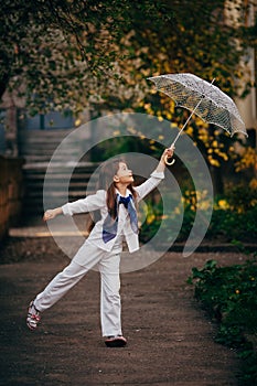 Little girl dancing with lace ambrella