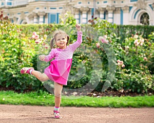 Little girl dancing in the park like ballerina