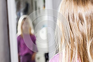 Little girl dancing and standing in front of the mirror