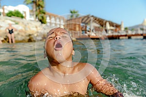 Little girl in danger drowning at the ocean