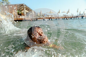 Little girl in danger drowning at the ocean