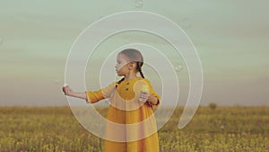 little girl daughter blowing soap bubbles park. children summer holiday soap bubbles. happy family. child kid has fun