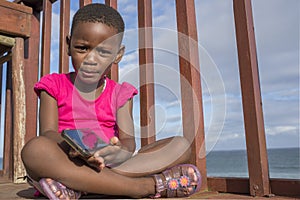 Little girl on deck with mobile phone