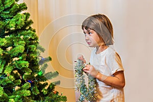 Little girl decorating Christmas tree