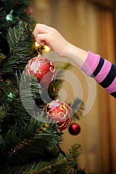Little girl decorating the Christmas tree photo