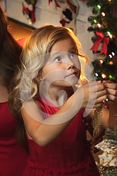 Of little girl decorating Christmas tree