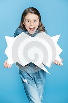 Little girl in denim overalls holding speech bubble and screaming