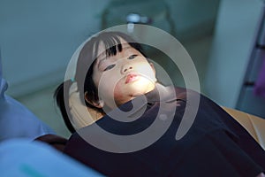 Little girl during dental extraction. Child with a teeth broken and rotten