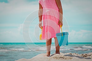 Little girl dig play on beach, child dig sand