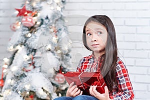 Little girl dissatisfied with Christmas gifts.