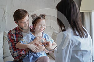 Little girl at the doctor for a checkup. Doctor woman auscultate the heartbeat of the child.