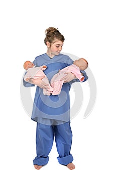 Little girl doctor holding twin baby dolls