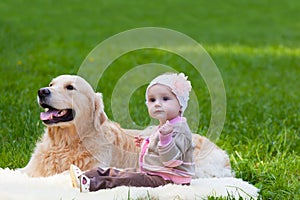 Little girl and dog of breed a golden retriever