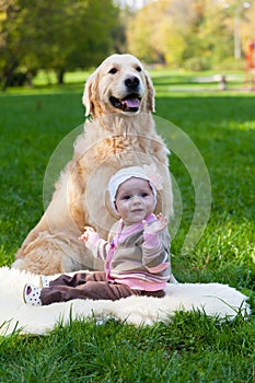 Little girl and dog of breed a golden retriever