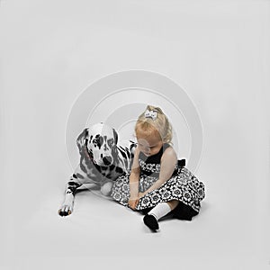 Little girl and dog Dalmatian