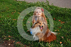 Little girl with a dog Sheltie