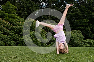Little girl doing a cartwheel photo