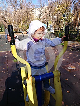 Little girl doing exercise in the park.