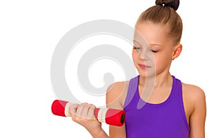 Little girl doing exercises with dumbbells.