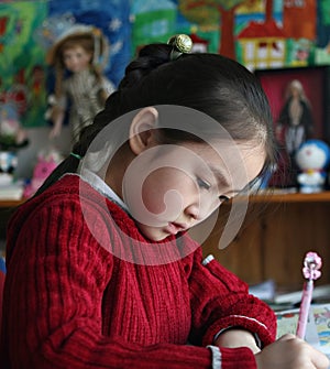 Little girl doing homework at home