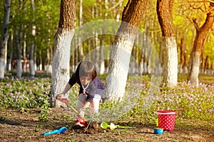 Little girl doing plantings in bright spring