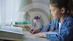 Little girl doing school assignment at home