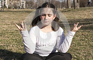 Little girl doing yoga meditating