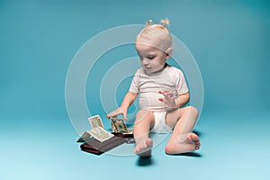 Little girl and dollars on a wallet