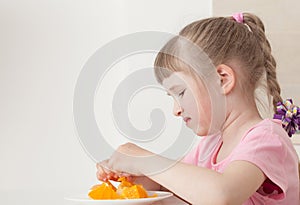 Little girl don't want to eat an orange