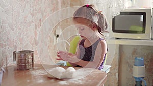 Little Girl With Dough On Kitchen. Child Learns Cook