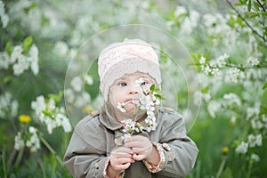 Little girl with Down syndrome smelling flowers