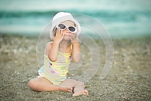 Little girl with Down syndrome wore glasses and poses faces