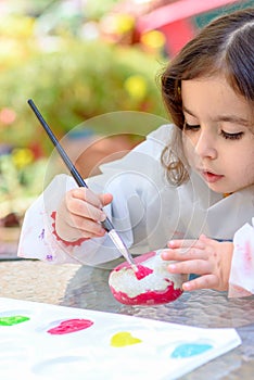 Little Girl Drawing On Stone Outdoors In Summer Sunny Day.