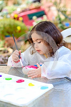 Little Girl Drawing On Stone Outdoors In Summer Sunny Day.