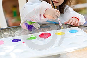 Little Girl Drawing On Stone Outdoors In Summer Sunny Day.