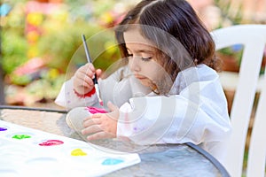 Little Girl Drawing On Stone Outdoors In Summer Sunny Day.