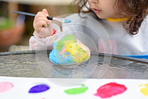 Little Girl Drawing On Stone Outdoors In Summer Sunny Day.