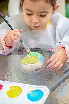 Little Girl Drawing On Stone Outdoors In Summer Sunny Day.